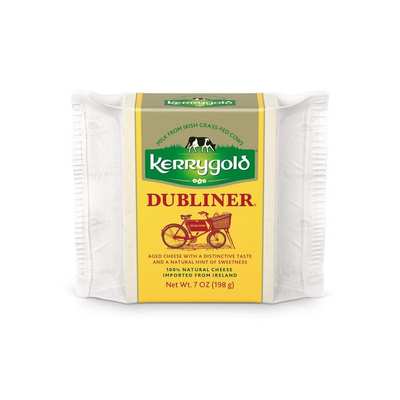 Kerrygold Dubliner cheese block with green and yellow packaging featuring a bicycle graphic.