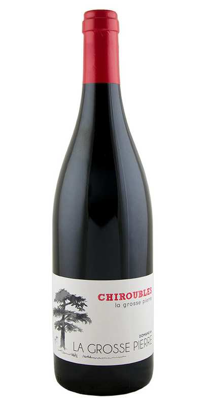 A bottle of Domaine de la Grosse Pierre Chiroubles with a red cap and a white label featuring a tree illustration.
