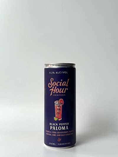 A 250 ml can of Social Hour Black Pepper Paloma with a dark purple design and cocktail illustration.